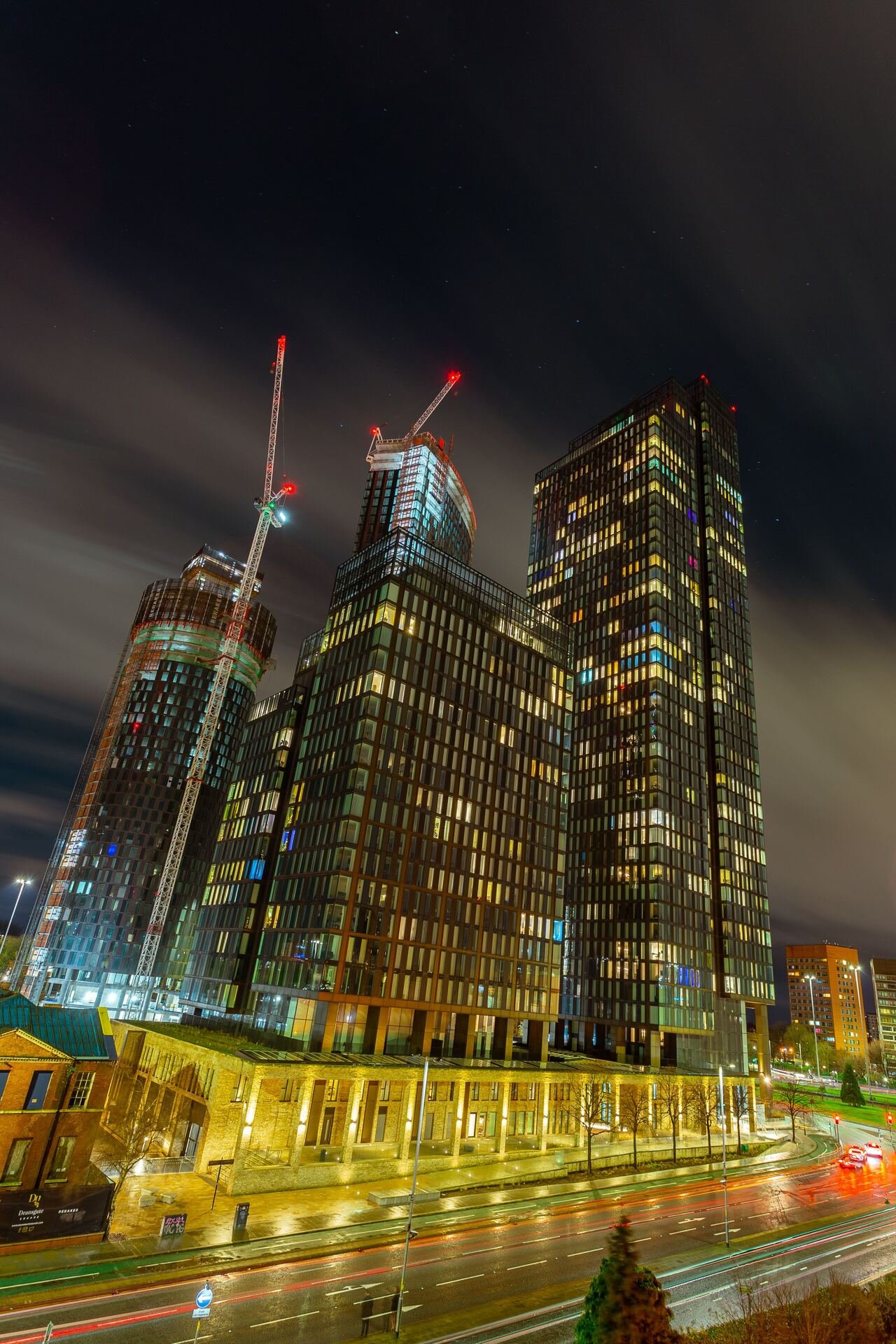 Long exposure of a city construction skyline at dusk